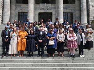 Participants of APEC 2026 stand on the steps of the NZ Parliament